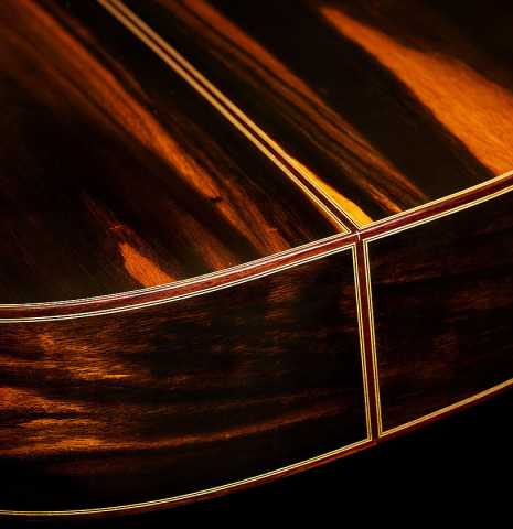 The back and sides at the foot of a 2024 Hermanos Camps "CL20-S" classical guitar made of spruce and exotic ebony