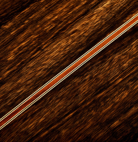 The back center seam of a 2025 Hermanos Camps "CL20-S" classical guitar made of spruce and exotic ebony