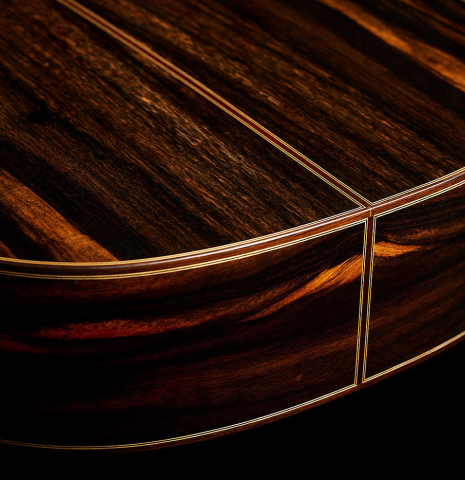 The sides at the foot of a 2025 Hermanos Camps "CL20-S" classical guitar made of spruce and exotic ebony