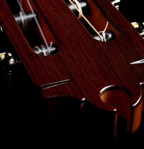The carved headstock of a 2026 Hermanos Camps "CL20-S" classical guitar made of spruce and exotic ebony