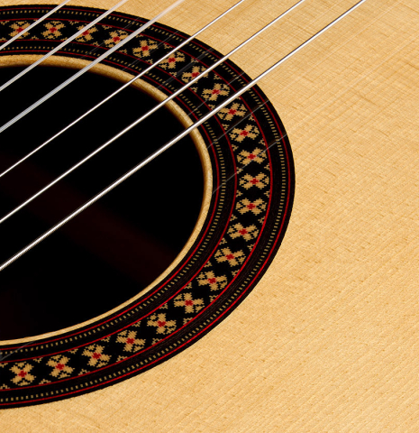 The soundboard and rosette detail of a 2026 Hermanos Camps "CL20-S" classical guitar made of spruce and exotic ebony
