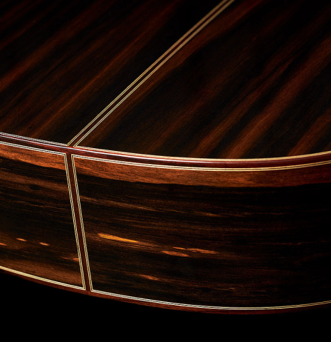 The back and sides at the foot of a 2024 Hermanos Camps "CL20-C" classical guitar made of cedar and exotic ebony