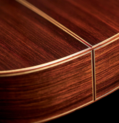 The lower bout of a 2023 Hermanos Camps "GL18C" classical guitar made with cedar and Indian rosewood.