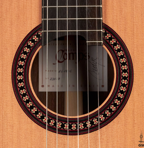 The rosette of a 2023 Hermanos Camps "GL18C" classical guitar made with cedar and Indian rosewood.
