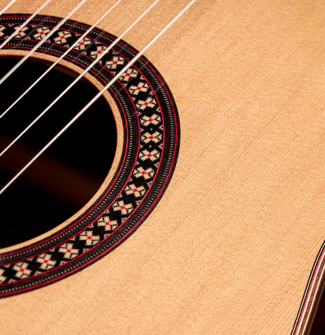 The soundboard of a 2023 Hermanos Camps "GL18C" classical guitar made with cedar and Indian rosewood.
