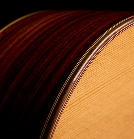 The top binding and purfling of a Hermanos Camps "CL18C" classical guitar made of cedar and Indian rosewood