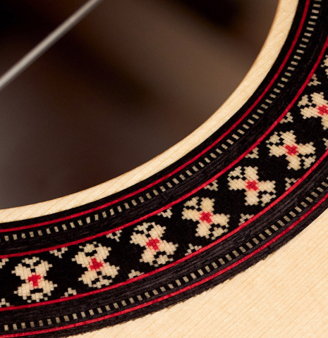 The rosette of a 2023 Hermanos Camps "GL18S" classical guitar made with spruce and Indian rosewood.
