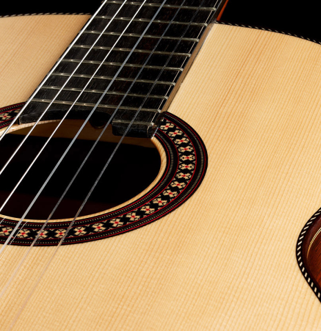 The soundboard and rosette of a 2024 Hermanos Camps "CL20-S" classical guitar made of spruce and Malaysian blackwood