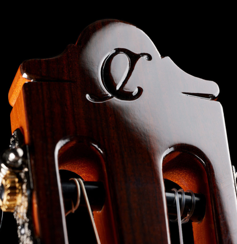 The headstock veneer with relief of a 2024 Hermanos Camps "CL20-C" classical guitar made of cedar and Malaysian blackwood