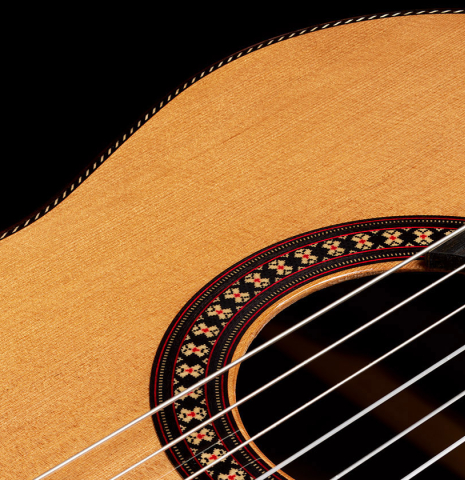 The soundboard and rosette detail of a 2024 Hermanos Camps "CL20-C" classical guitar made of cedar and Malaysian blackwood
