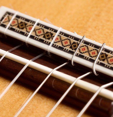 The bridge, tie-block and saddle of a 2021 Vicente Carrillo "Primera Especial" made with cedar and African rosewood