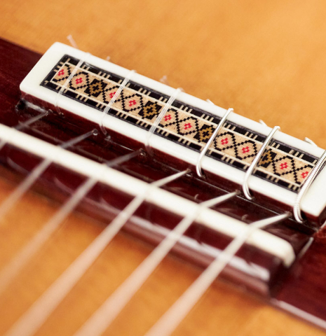 The bridge and saddle of a Vicente Carrillo "Primera Especial" classical guitar made with cedar top and African rosewood back and sides