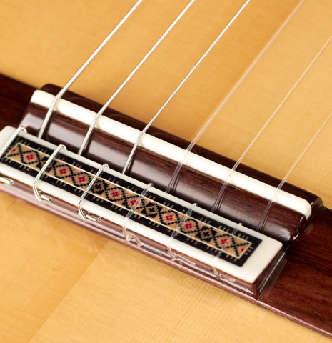 The tie block of a Vicente Carrillo "Primera Especial" classical guitar made with spruce and African rosewood.