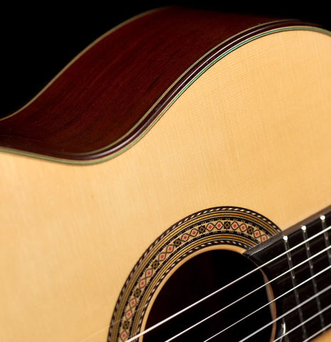 The soundboard and rosette of a Vicente Carrillo "Primera Especial" classical guitar made with spruce and African rosewood.