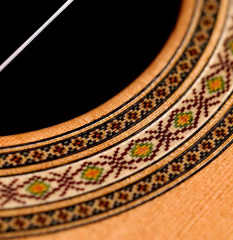 The close-up of a rosette of a Vicente Carrillo "India Estudio" guitar made with cedar and Indian rosewood