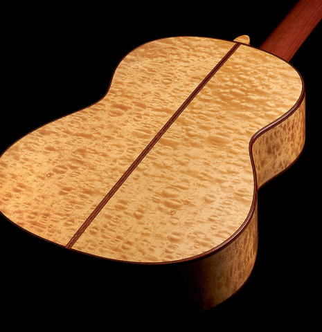 The maple back and sides of a 2022 Vicente Carrillo "Maestro Double Top" classical guitar made with spruce top