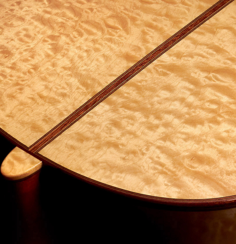The maple back and heel of a 2022 Vicente Carrillo "Maestro Double Top" classical guitar made with spruce top