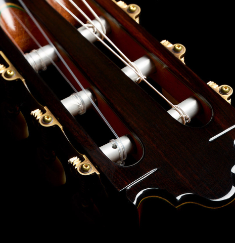 The headstock veneer and tuning machine rollers of a 2025 Vicente Carrillo "Primera Especial" classical guitar made of cedar and Malaysian blackwood