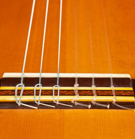 The bridge and tie block of a 1968 Manuel de la Chica classical guitar made with spruce and CSA rosewood.