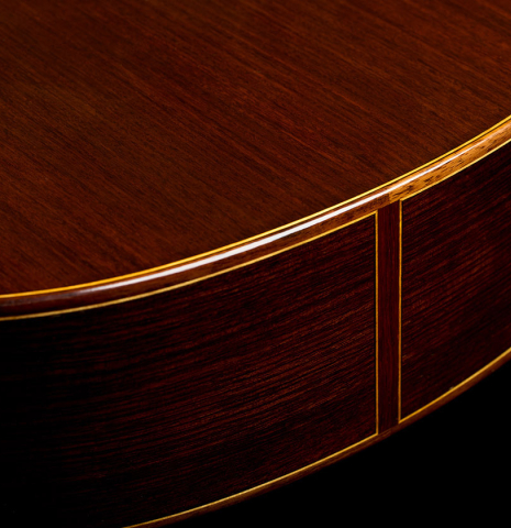 The back and sides at the foot of a 2025 Moonseok Choi classical guitar made of spruce and Indian rosewood