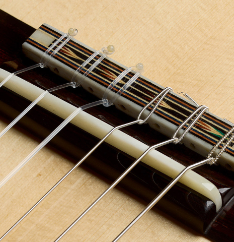 The bridge, tie-block and saddle of a 2025 Moonseok Choi classical guitar made of spruce and Indian rosewood