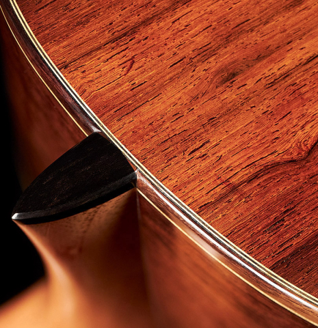 The heel of a 2023 Moonseok Choi classical guitar made with spruce and African rosewood.