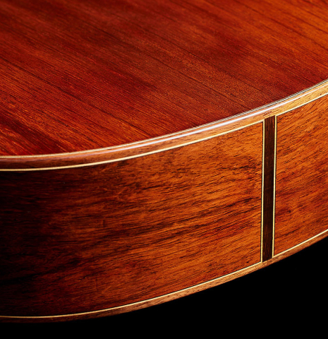 The back and sides at the foot of a 2024 Moonseok Choi "Nomad" classical guitar made of spruce and African rosewood