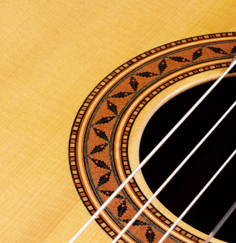 Detailed close-up of the rosette of a 2024 Moonseok Choi "Nomad" classical guitar made of spruce and African rosewood