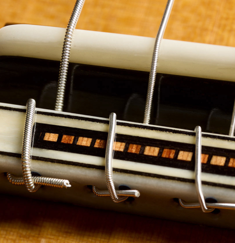 The bridge, tie-block and saddle of a 2025 Moonseok Choi classical guitar made of cedar and African rosewood