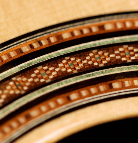 A close-up of a rosette of a 2001 Brian Cohen classical guitar made with spruce and CSA rosewood
