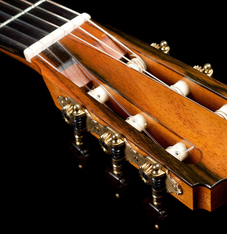 The headstock and tuners of a 2001 Brian Cohen classical guitar made with spruce and CSA rosewood