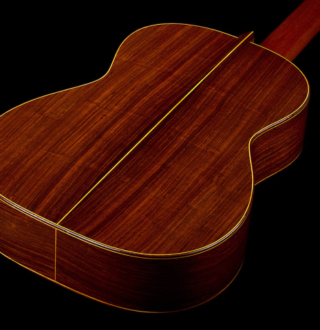 The back and sides of a 1990 Brian Cohen classical guitar made of spruce and Indian rosewood