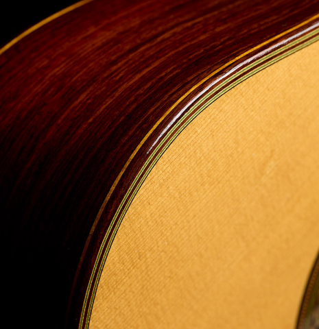 The top binding and purflings of a 1990 Brian Cohen classical guitar made of spruce and Indian rosewood