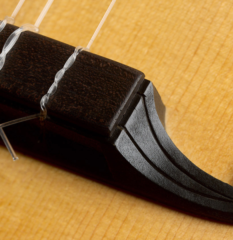 The carved bridge of a 1994 Brian Cohen "8-Course Renaissance Lute" made of spruce and maple