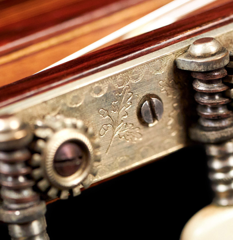 The machine heads of a 1934 Enrique Coll classical guitar made of spruce and CSA rosewood