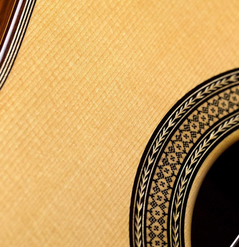 Closeup of the soundboard and rosette of a 2009 Manuel Contreras II "Especial" classical guitar made of spruce and African rosewood