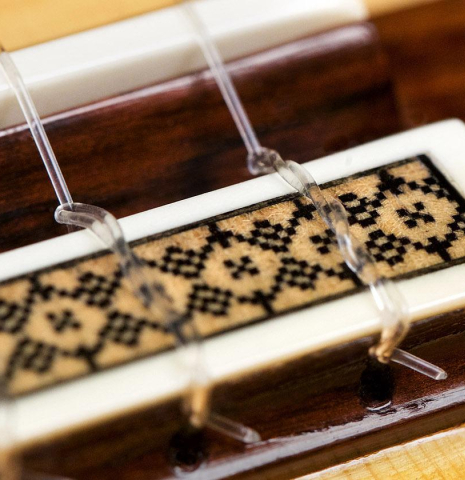 The bridge, tie-block and saddle of a 2009 Manuel Contreras II "Especial" classical guitar made of spruce and African rosewood