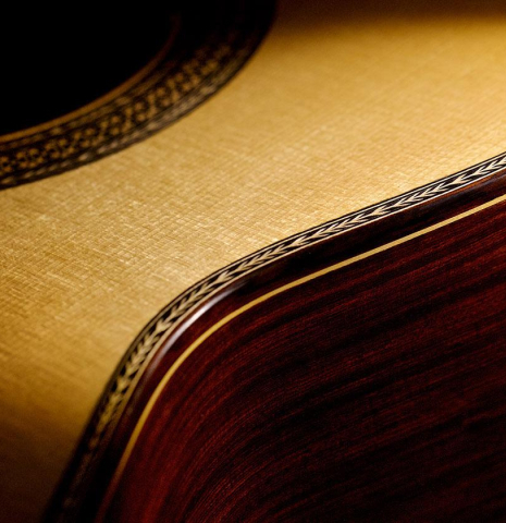 The top binding and purfling of a 2005 Manuel Contreras II "Double Top" classical guitar made of spruce and CSA rosewood