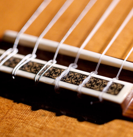 The bridge and saddle of a 2009 Manuel Contreras II "Double Top" classical guitar made with cedar top and CSA rosewood back and sides.