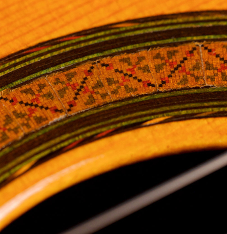 A close-up of the rosette of a 1966 Manuel Contreras classical guitar made with cedar and Indian rosewood