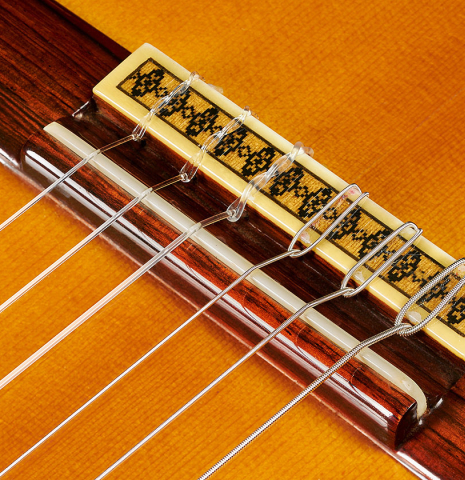 The bridge, tie-block and saddle of a 1971 Manuel Contreras classical guitar made of spruce and CSA rosewood