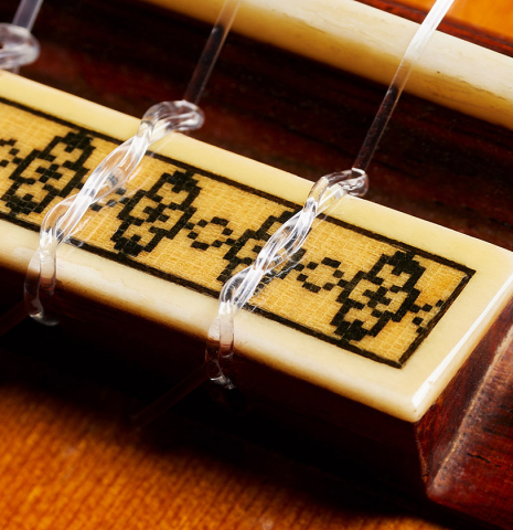 The bridge, tie-block and saddle of a 1973 Manuel Contreras classical guitar made of cedar and CSA rosewood