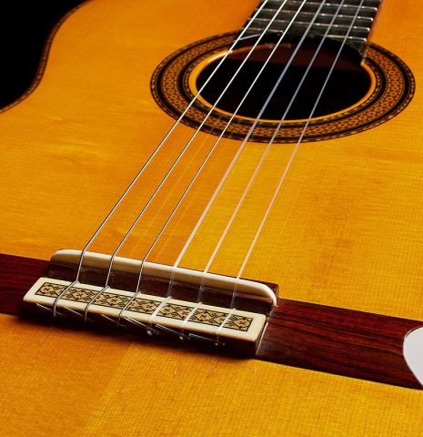 The soundboard, bridge, tie-block and saddle of a 1985 Manuel Contreras "Double Top" classical guitar made of spruce and CSA rosewood