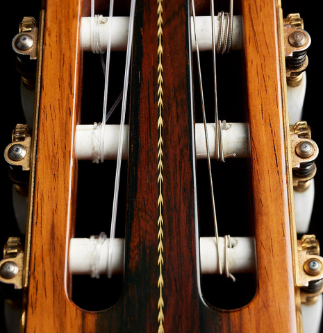 The headstock veneer and tuning machines of a 1985 Manuel Contreras "Double Top" classical guitar made of spruce and CSA rosewood
