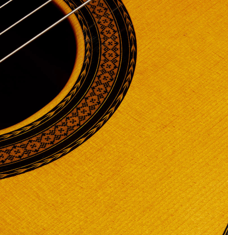 The soundboard and rosette detail of a 1985 Manuel Contreras "Double Top" classical guitar made of spruce and CSA rosewood