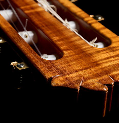 The headstock and tuning machines of a 2016 Stephan Connor "640" classical guitar made of spruce and koa
