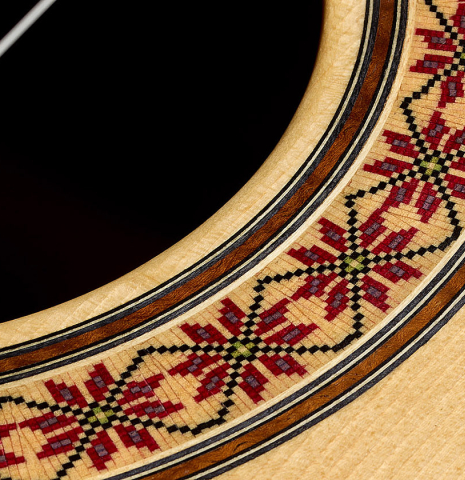 Closeup detail of the rosette of a 2016 Stephan Connor "640" classical guitar made of spruce and koa