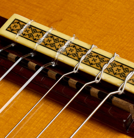 The bridge, tie-block and saddle of a 1986 Manuel Contreras "Double Top" classical guitar made of spruce and CSA rosewood