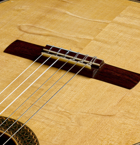 The soundboard and bridge of a 2017 Stephan Connor "640" classical guitar made of spruce and African rosewood