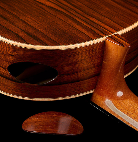 The back, sides and soundport with cover of a 2017 Stephan Connor "640" classical guitar made of spruce and African rosewood
